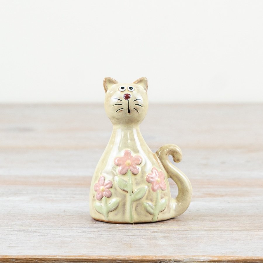 Glossy pastel pink cat adorned with daisy patterns and finished with a clear glaze.