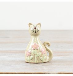 Glossy pastel green cat adorned with daisy patterns and a sleek clear glaze finish.