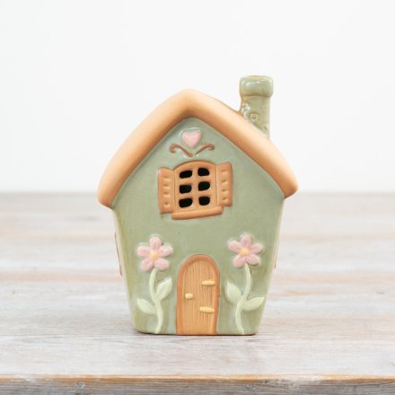 Charming tea light holder featuring a cozy house design.
