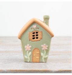 Charming tea light holder featuring a cozy house design.