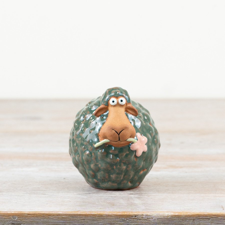 Charming green porcelain sheep ornament, delicately crafted with a flower in its mouth