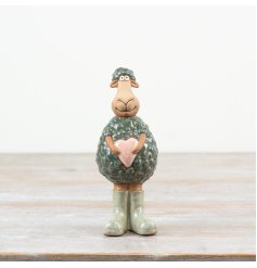 Adorable porcelain standing sheep ornament holding a heart, perfect for charming decor.
