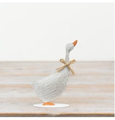Charming metal duck decoration adorned with an adorable bow.