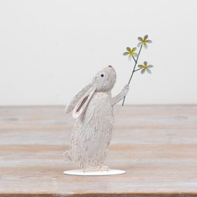 Bring spring indoors with this cute metal rabbit holding a vibrant yellow daisy. Charming décor for any space!