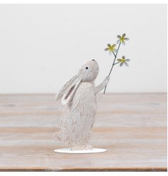 Add a charming touch to your spring décor with this delightful metal rabbit holding a bright yellow daisy
