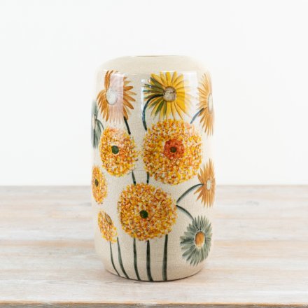 The Dandelion Ceramic Vase features a beautiful glazed orange finish and a subtle dandelion desig