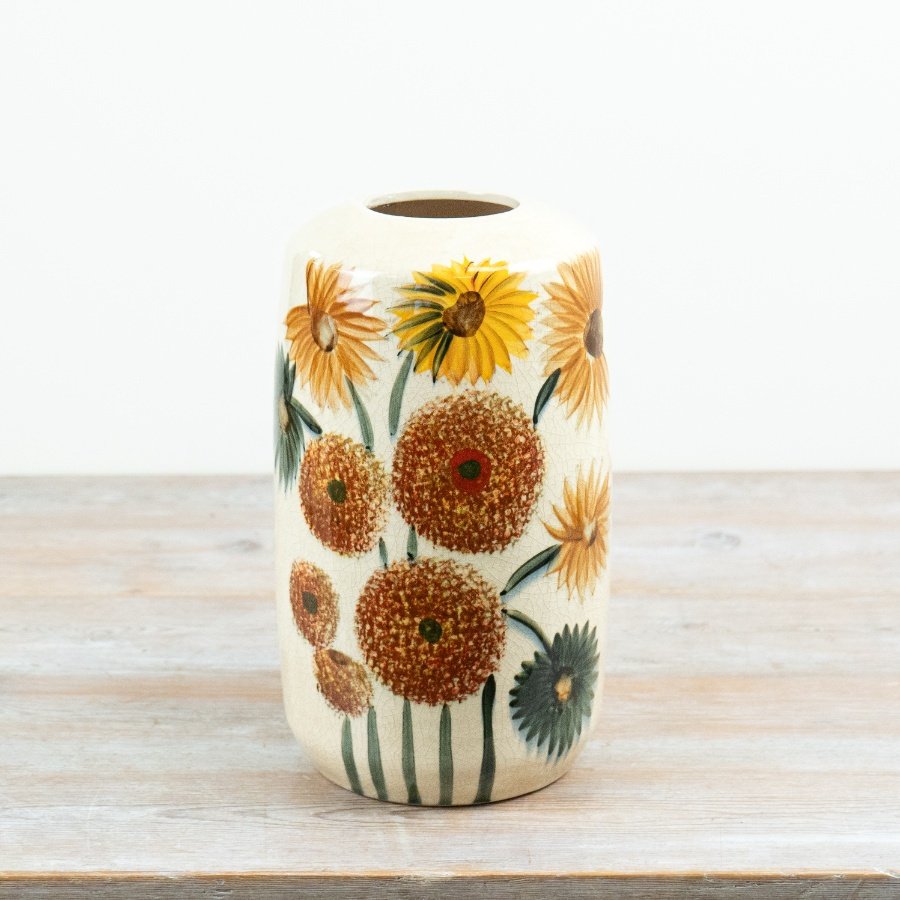 The Sunflower Ceramic Vase showcases a glossy orange glaze with a delicate dandelion pattern.