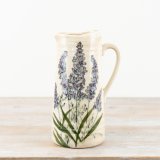 A rustic glazed jug displaying beautiful lavender illustrations.