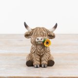 Experience a touch of rustic elegance with this highland cow ornament