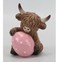 Celebrate Easter with our charming Highland Cow adorned with an Easter Egg!