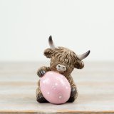 Add a touch of Scottish charm to your Easter celebrations with our adorable Highland Cow With Easter Egg Decor,