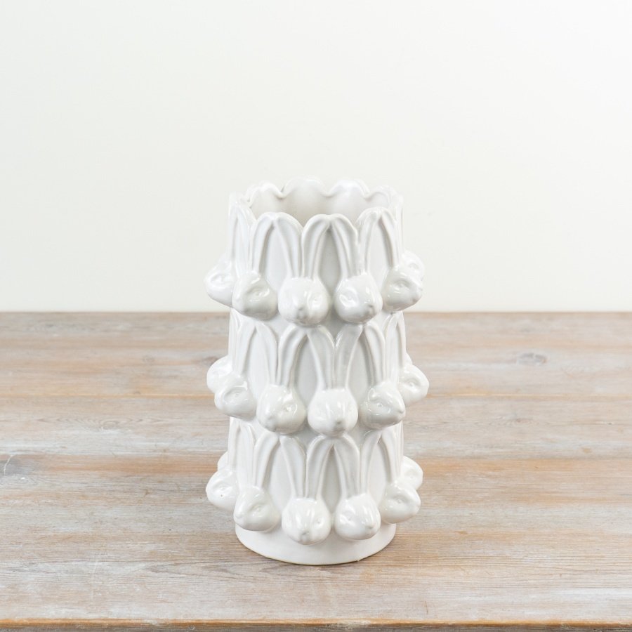 Elegant tall white vase featuring a repeating bunny head design for a charming touch.