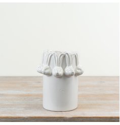 Welcome spring with this stylish white vase featuring a charming repeating bunny head design.