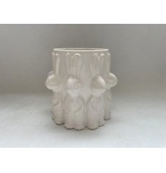 A lovely white vase adorned with cute rabbit figures around the design.
