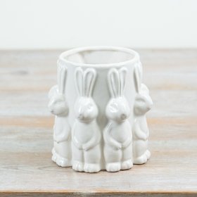 A delightful white vase adorned with cute rabbits all around.