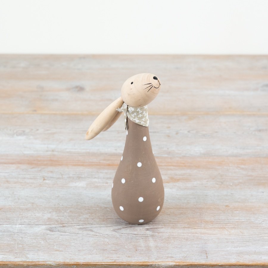 Add a spring touch to your décor with this wooden bunny, featuring a classic brown polkadot design.