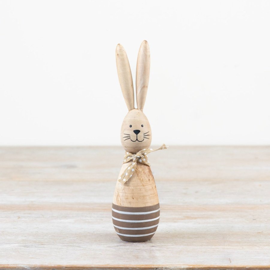 Add a charming touch to your space with this striped and polkadot-adorned wooden bunny. Hop into Easter season in styl