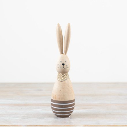 A charming wooden rabbit wearing a polkadot scarf 