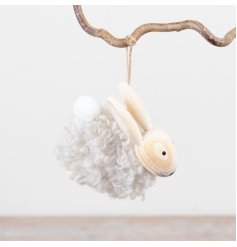 A sherpa rabbit in a neutral colour tone hung by jute twine.