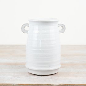 A classic vase with a delicate white glaze finish and small eared handled. A hand finished item characterful features.