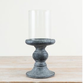 Add a subtle, earthy touch to your space with this natural-toned cement candle holder. 
