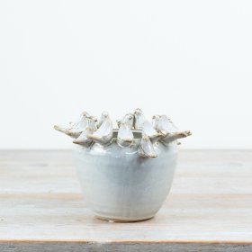 Adorable planter featuring a delightful bird motif.