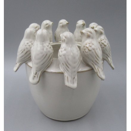 Adorable planter featuring a cute bird motif.