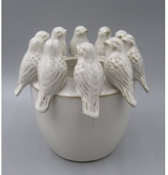 Adorable planter featuring a cute bird motif.