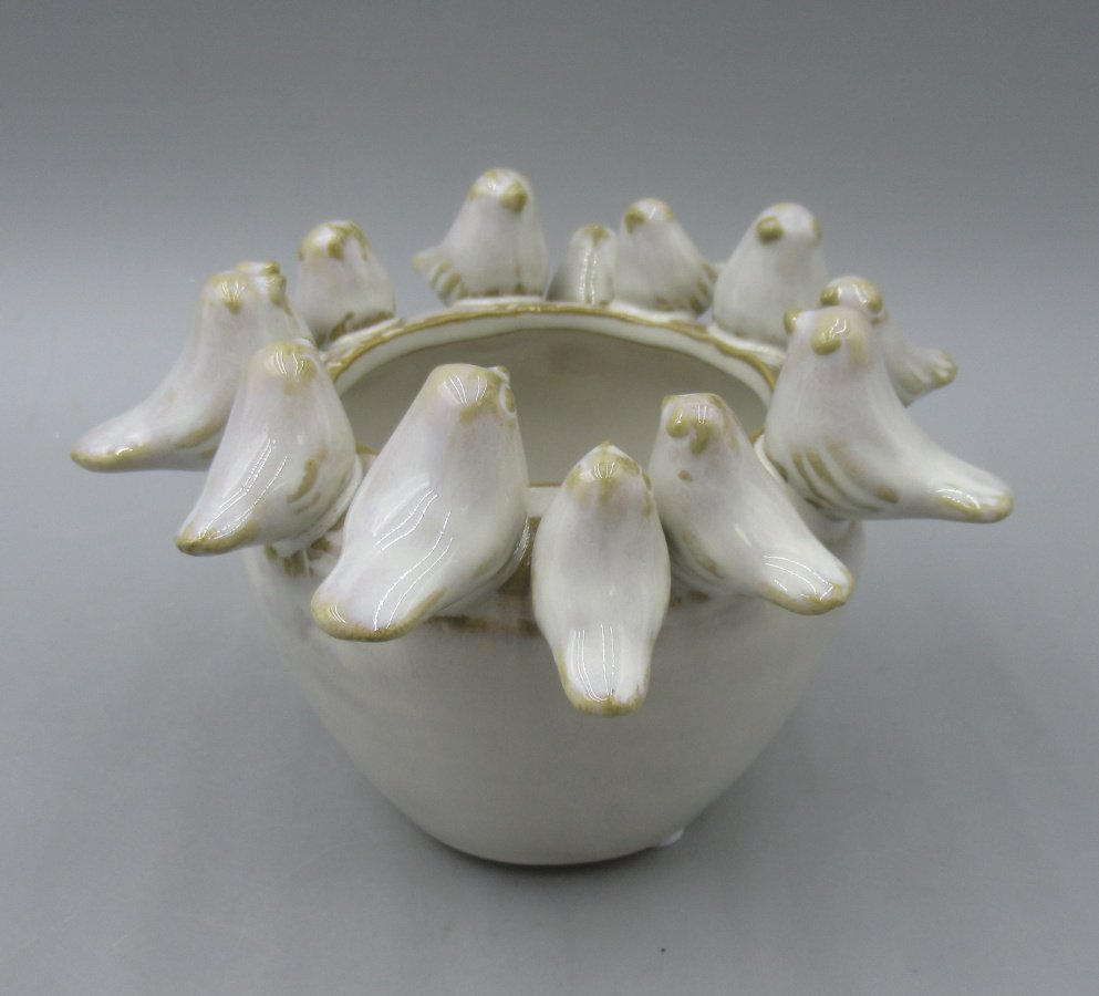 Adorable planter featuring a delightful bird motif.