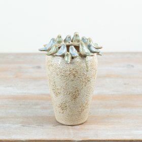 Enhance your home decor with this stone vase featuring charming glazed birds. A must-have for any room.