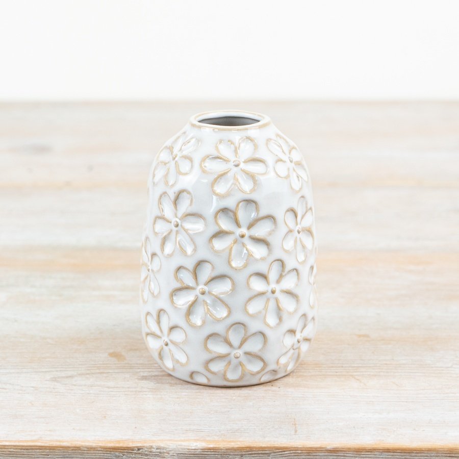 Unique shabby chic vase adorned with a glazed flower motif.