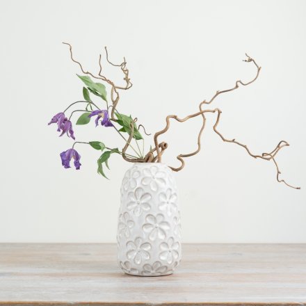 Add charm to your decor with a whimsical porcelain vase featuring a delightful daisy design.