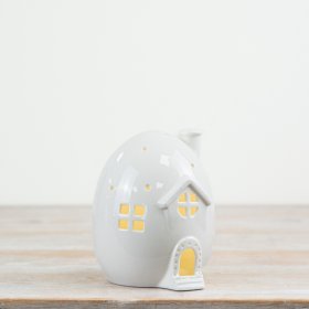 A unique egg shaped house with warm glow LED lights. Complete with patterned details, front steps and cosy cottage. 