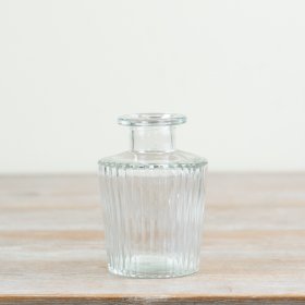 Elegant clear glass vase featuring a subtle ribbed design.
