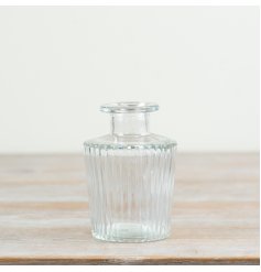 Elegant clear glass vase featuring a sleek ribbed design.