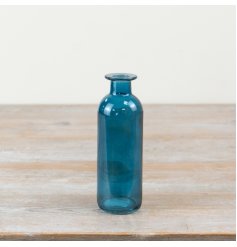 The Glass Blue Bottle Vase brings elegant charm with its deep, vibrant blue color.