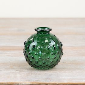 Add a touch of style to your space with a green vase featuring a unique bobble pattern. 