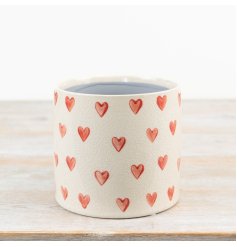 Add a touch of charm with our elegant cream planter, embellished with charming painted red hearts.