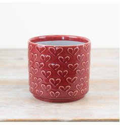 Transform your space with this charming red planter featuring an elegant embossed heart design.