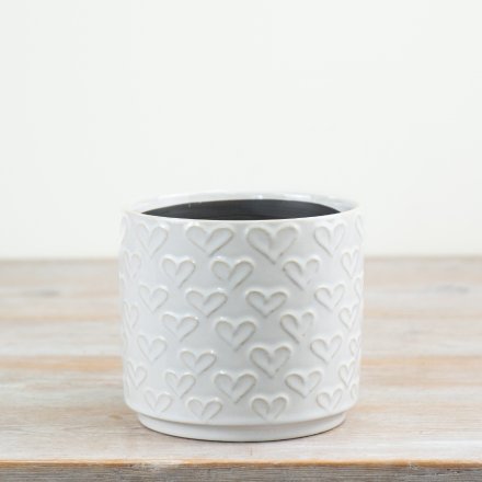 Glossy white planter featuring delicate embossed love heart designs.