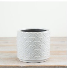 Glossy white planter featuring delicate embossed love heart designs.