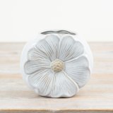 A unique and pretty daisy shaped vase with a glossy white and raw glaze. 