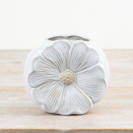A unique and pretty daisy shaped vase with a glossy white and raw glaze. 