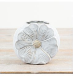 A unique and pretty daisy shaped vase with a glossy white and raw glaze. 