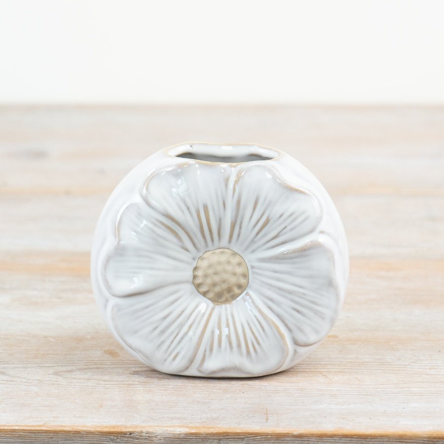 A charming daisy shaped vase with a white glossy glaze and raw details. 