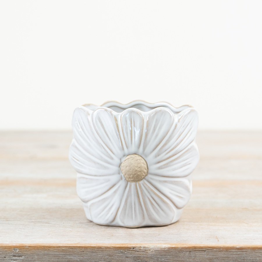 A pretty daisy shaped vase with a rich white glaze and raw details. 