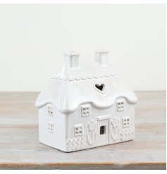 Elegant tea light holder featuring a neutral house motif for stylish home decor.