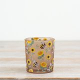 Brighten your space with this charming glass candle holder