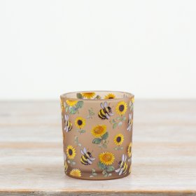 Illuminate your room with this lovely glass candle holder featuring intricate sunflowers and bees.