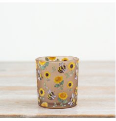 Light up your space with this glass candle holder featuring lovely sunflowers and bees.